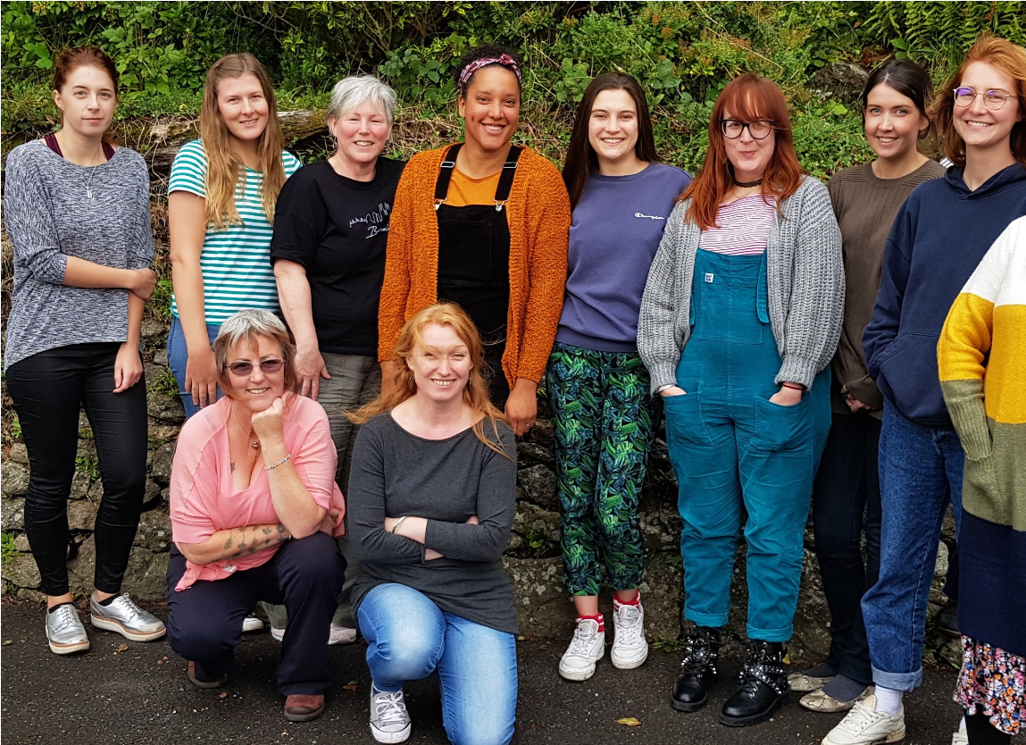 Training group - 12 smiling women outside